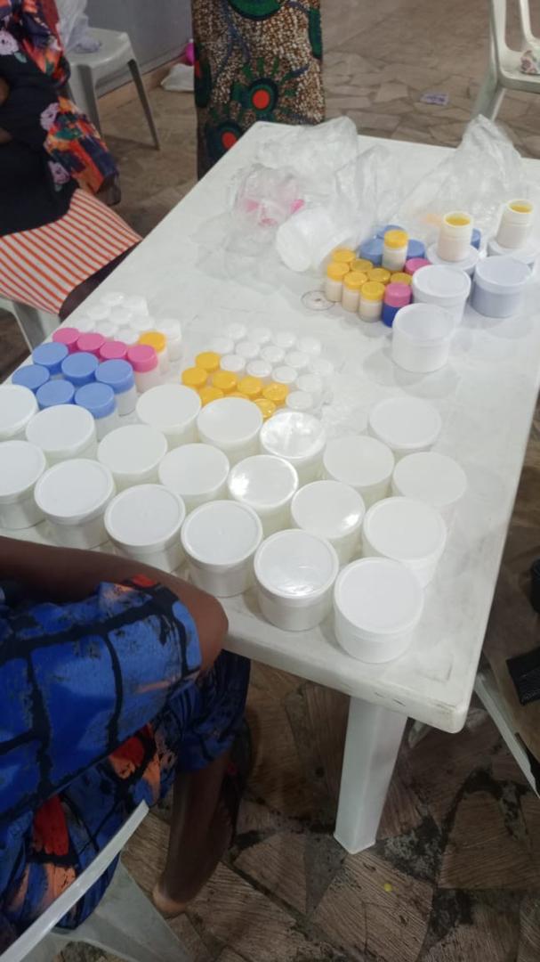 Cream products in white containers with colourful lids arranged during PETVOS training